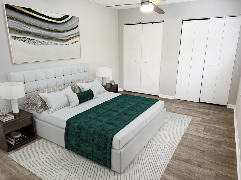 a bedroom with a white bed and a green blanket